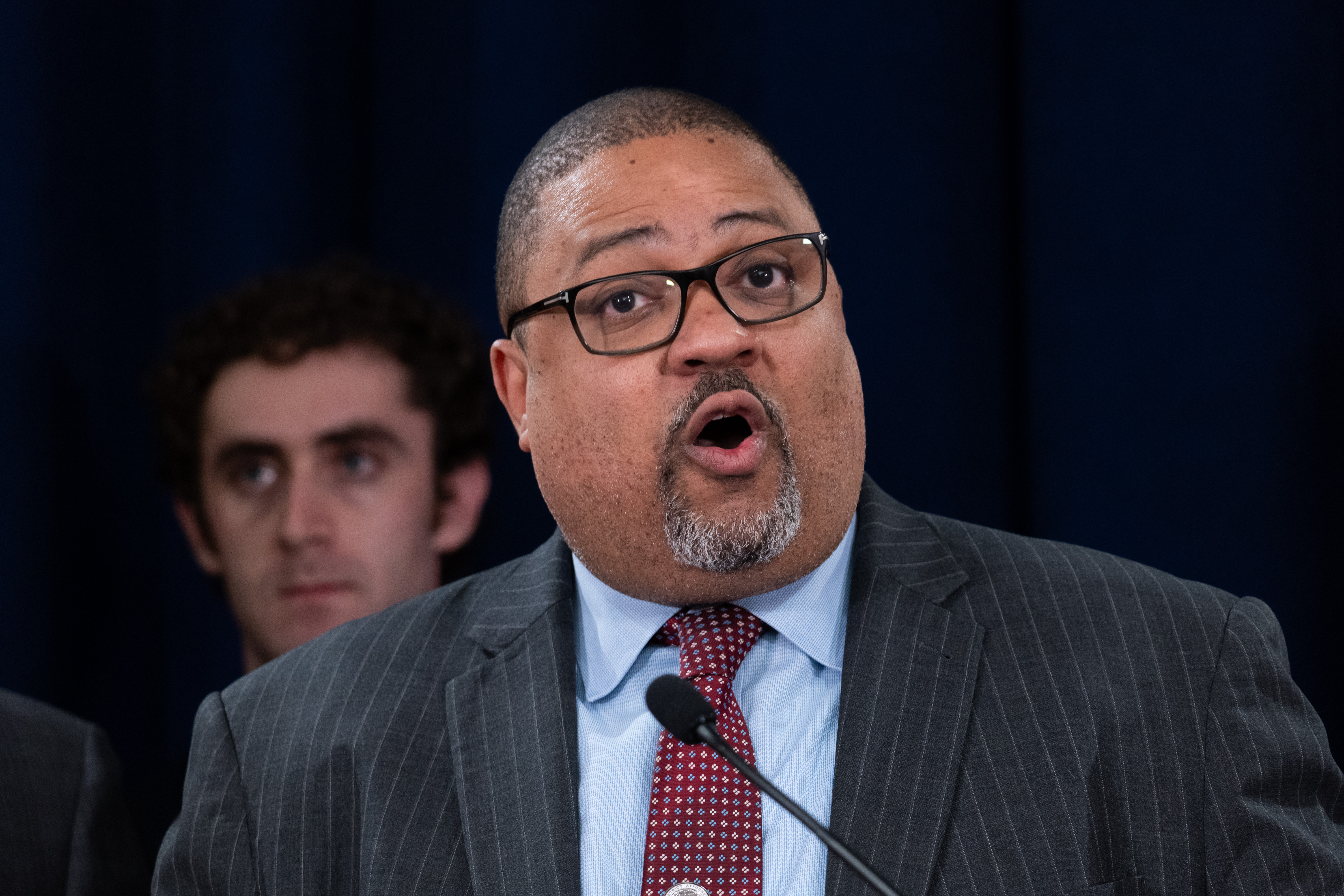 Manhattan District Attorney Alvin Bragg stands with members of his staff at a news conference in May.